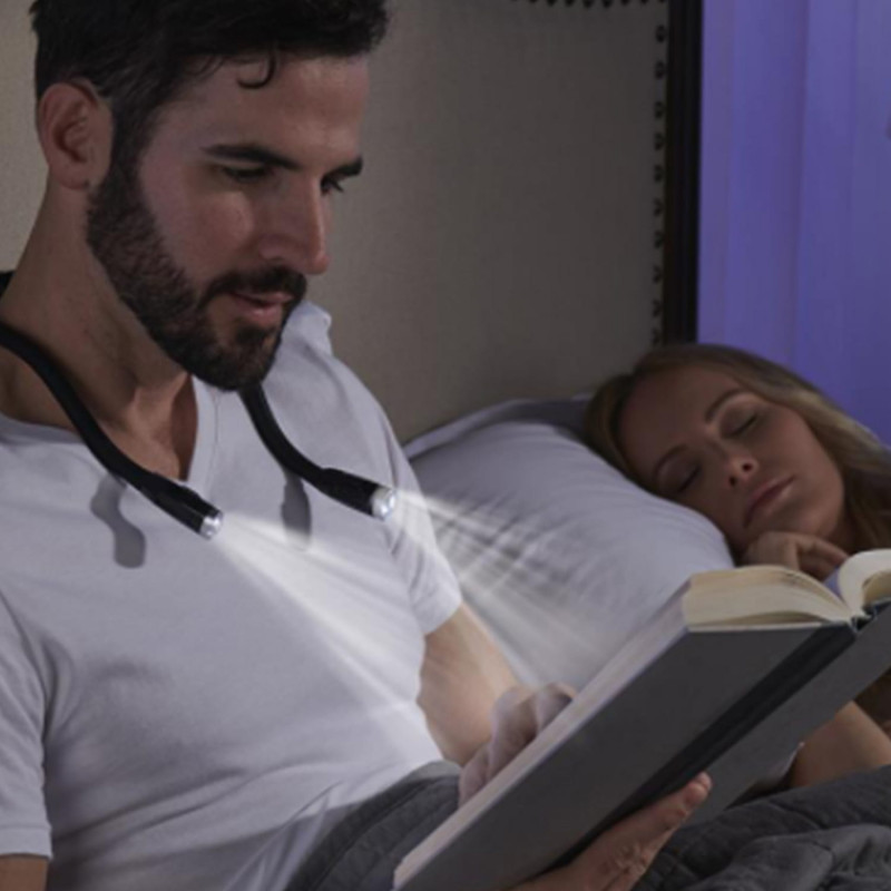 Personne portant un cordon équipé d'une lampe pour lire au lit